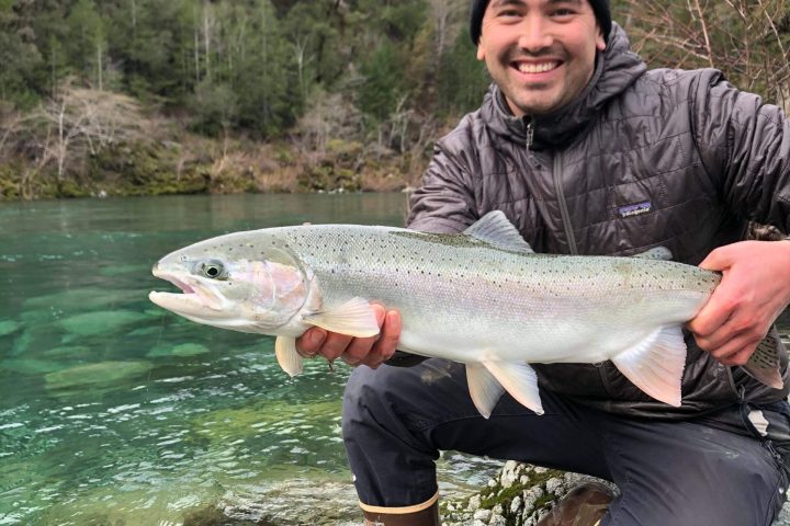 a man holding a fish in the water