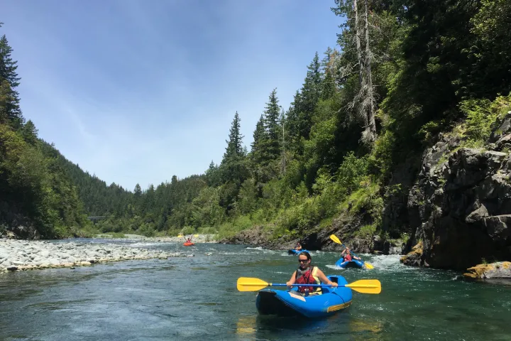 single kayakers paddling down river